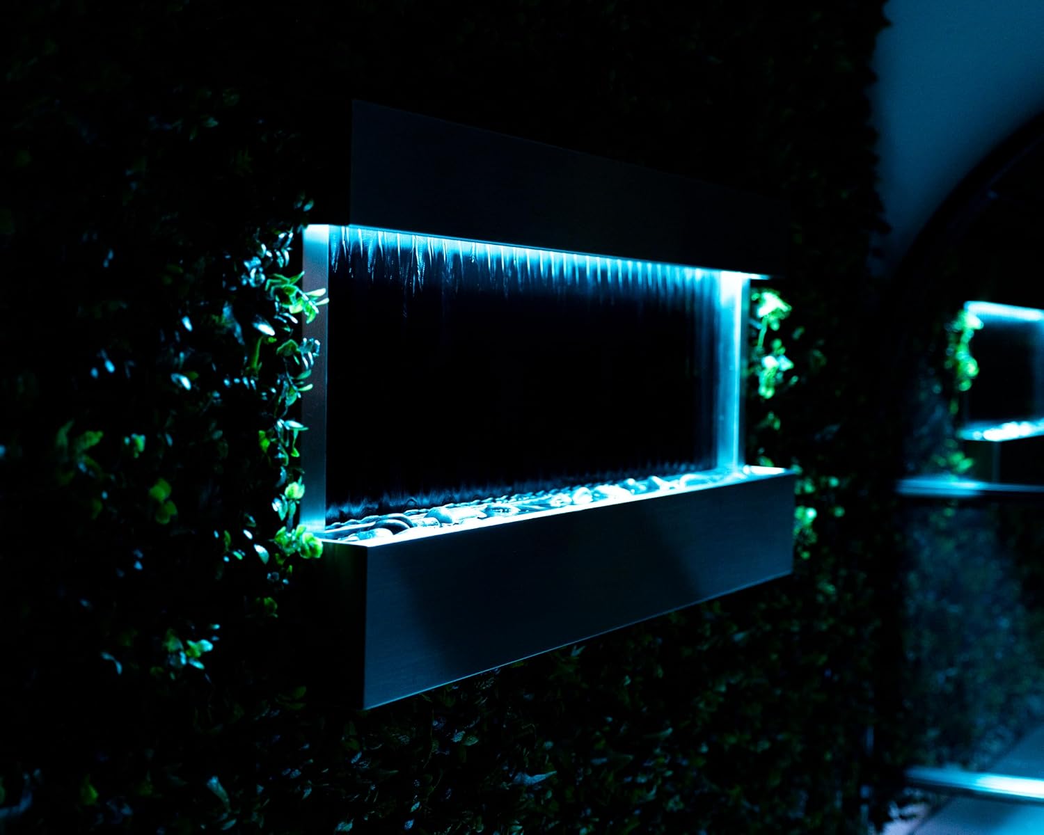 XBrand 47' Indoor Wall-Mounted Waterfall Mirror Fountain with LED Lighting, Silver Metal Décor, and Rock Base – Modern Relaxing Water Feature for Home