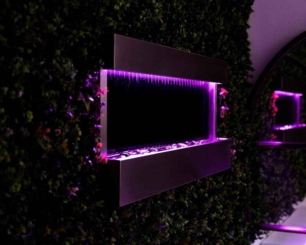 XBrand 47' Indoor Wall-Mounted Waterfall Mirror Fountain with LED Lighting, Silver Metal Décor, and Rock Base – Modern Relaxing Water Feature for Home